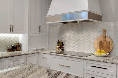 Inspiration for a mid-sized transitional l-shaped light wood floor eat-in kitchen remodel in Miami with an undermount sink, recessed-panel cabinets, white cabinets, granite countertops, white backsplash, glass tile backsplash, stainless steel appliances and an island