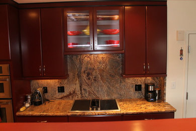 Mid-sized galley enclosed kitchen photo in Boston with flat-panel cabinets, medium tone wood cabinets, stainless steel appliances and an island
