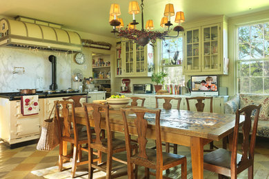 Example of a farmhouse eat-in kitchen design in Providence with glass-front cabinets, white backsplash, stone slab backsplash and white appliances