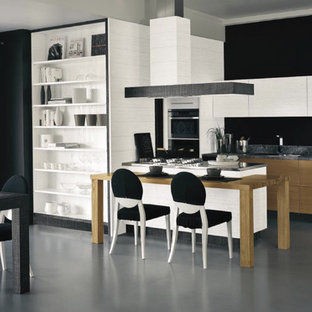 This is an example of a contemporary eat-in kitchen in London with flat-panel cabinets and medium wood cabinets.