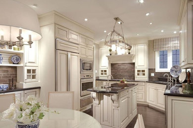 Example of a mid-sized classic u-shaped dark wood floor eat-in kitchen design in Toronto with raised-panel cabinets, white cabinets, granite countertops, gray backsplash, ceramic backsplash, paneled appliances and an island