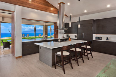 Inspiration for a large contemporary l-shaped beige floor and porcelain tile open concept kitchen remodel in Hawaii with an undermount sink, flat-panel cabinets, window backsplash, paneled appliances, an island, dark wood cabinets and quartz countertops