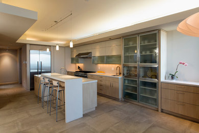 Inspiration for a modern kitchen remodel in San Luis Obispo with flat-panel cabinets, light wood cabinets, beige backsplash, stainless steel appliances and an island
