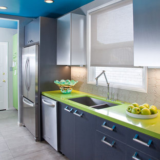 This is an example of a mid-sized contemporary single-wall separate kitchen in Other with an undermount sink, flat-panel cabinets, stainless steel cabinets, quartz benchtops, grey splashback, ceramic splashback, stainless steel appliances, porcelain floors, no island and green benchtop.
