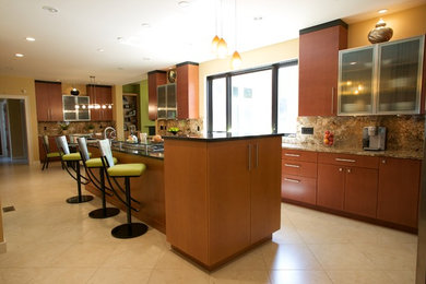 Large contemporary l-shaped kitchen/diner in St Louis with a submerged sink, flat-panel cabinets, medium wood cabinets, multi-coloured splashback, stone slab splashback, stainless steel appliances, porcelain flooring and an island.