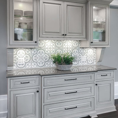 Mid-sized elegant dark wood floor and brown floor kitchen photo in Chicago with an undermount sink, raised-panel cabinets, beige cabinets, granite countertops, gray backsplash, ceramic backsplash and stainless steel appliances