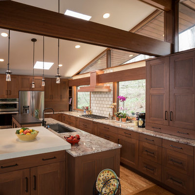 Eat-in kitchen - craftsman l-shaped eat-in kitchen idea in Wilmington with recessed-panel cabinets, stainless steel appliances, subway tile backsplash, medium tone wood cabinets, an undermount sink, granite countertops and beige backsplash