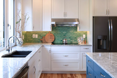 Mid-sized transitional kitchen photo in Other with white cabinets, green backsplash, ceramic backsplash and an island
