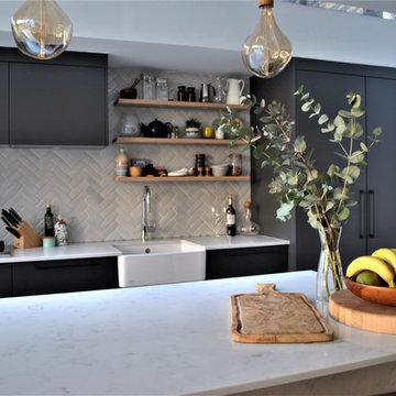 Modern dark grey kitchen with black handles