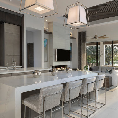 Kitchen - large modern porcelain tile and beige floor kitchen idea in Miami with an undermount sink, flat-panel cabinets, dark wood cabinets, paneled appliances, two islands and white countertops