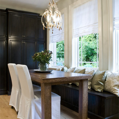 Eat-in kitchen - large traditional galley light wood floor eat-in kitchen idea in Chicago with raised-panel cabinets, dark wood cabinets, stainless steel appliances and an island