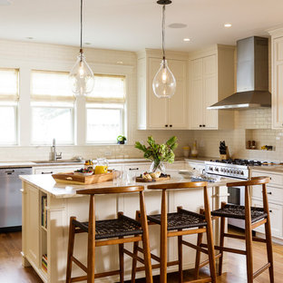 Large transitional open concept kitchen ideas - Open concept kitchen - large transitional l-shaped medium tone wood floor open concept kitchen idea in Providence with an undermount sink, recessed-panel cabinets, white cabinets, marble countertops, white backsplash, ceramic backsplash, stainless steel appliances and an island