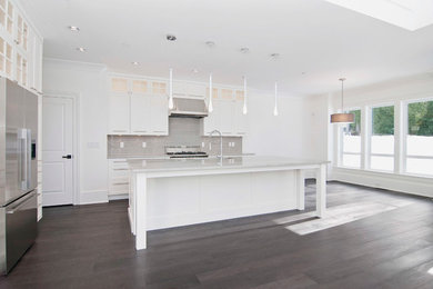 Inspiration for a contemporary dark wood floor eat-in kitchen remodel in Vancouver with an undermount sink, shaker cabinets, white cabinets, granite countertops, gray backsplash, glass tile backsplash and stainless steel appliances