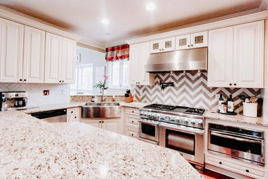 Country kitchen photo in Richmond with a farmhouse sink, gray backsplash, stainless steel appliances and an island