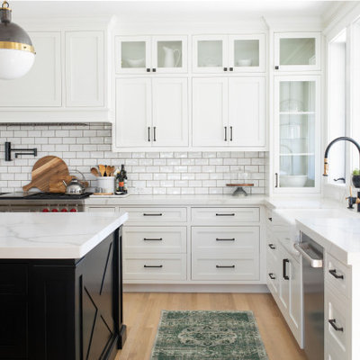 Large country light wood floor kitchen photo in Sacramento with a farmhouse sink, shaker cabinets, white cabinets, quartz countertops, white backsplash, subway tile backsplash, white countertops and an island