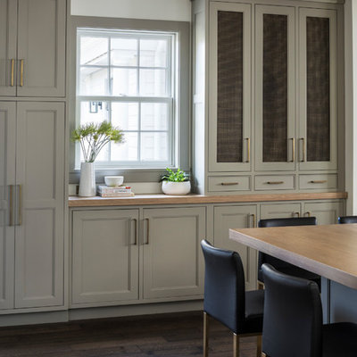Eat-in kitchen - large country l-shaped medium tone wood floor and brown floor eat-in kitchen idea in New York with a double-bowl sink, shaker cabinets, beige cabinets, quartz countertops, white backsplash, ceramic backsplash, black appliances, an island and white countertops
