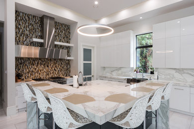 Inspiration for a mid-sized contemporary l-shaped marble floor and white floor open concept kitchen remodel in Miami with flat-panel cabinets, white cabinets, marble countertops, multicolored backsplash, marble backsplash, stainless steel appliances, an island and a farmhouse sink
