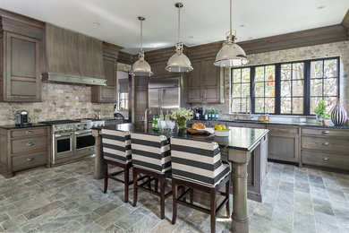 Open concept kitchen - mid-sized rustic l-shaped travertine floor and gray floor open concept kitchen idea in Minneapolis with an undermount sink, recessed-panel cabinets, multicolored backsplash, stainless steel appliances, an island, dark wood cabinets and stone tile backsplash