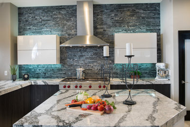Inspiration for a large l-shaped porcelain tile open concept kitchen remodel in Tampa with an undermount sink, flat-panel cabinets, black cabinets, quartz countertops, gray backsplash, ceramic backsplash, an island and stainless steel appliances