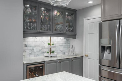 Transitional enclosed kitchen photo in Atlanta with glass-front cabinets, gray cabinets, matchstick tile backsplash, stainless steel appliances and an island