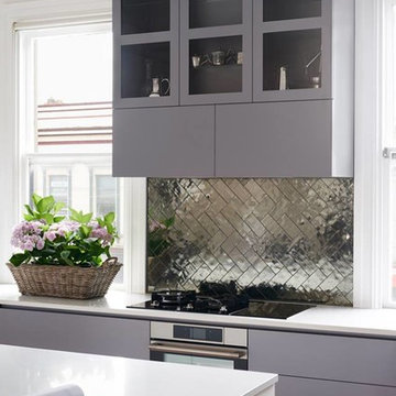 Modern grey kitchen with silver metallic herringbone backsplash