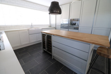 Photo of a medium sized modern grey and cream kitchen in Belfast.