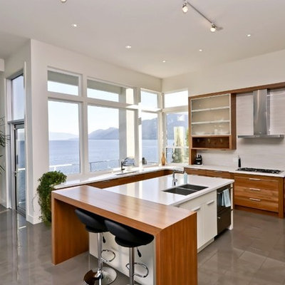 Eat-in kitchen - large contemporary u-shaped porcelain tile eat-in kitchen idea in Other with flat-panel cabinets, medium tone wood cabinets, white backsplash, quartz countertops, porcelain backsplash, stainless steel appliances, an island and an undermount sink
