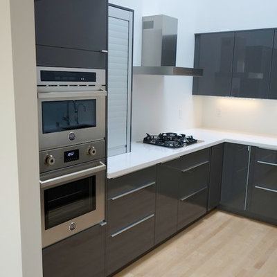 Inspiration for a modern u-shaped enclosed kitchen remodel in San Francisco with an undermount sink, flat-panel cabinets, gray cabinets, quartz countertops, white backsplash and stainless steel appliances