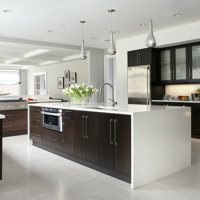 Inspiration for a contemporary white floor kitchen remodel in New York with flat-panel cabinets, stainless steel appliances and dark wood cabinets
