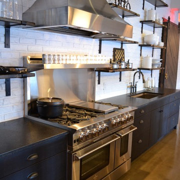 Modern Industrial Kitchen with Blue Cabinets and Stainless Range and Hood