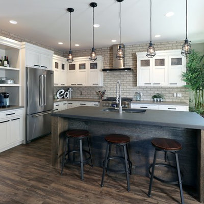Urban l-shaped dark wood floor kitchen photo in Grand Rapids with a double-bowl sink, recessed-panel cabinets, white cabinets, concrete countertops, stainless steel appliances and an island