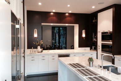 Inspiration for a modern u-shaped kitchen remodel in San Francisco with a drop-in sink, flat-panel cabinets, white cabinets, marble countertops, black backsplash, stainless steel appliances and an island