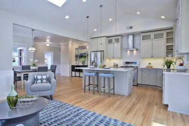 Open concept kitchen - large transitional l-shaped light wood floor and brown floor open concept kitchen idea in San Francisco with shaker cabinets, gray cabinets, marble countertops, stainless steel appliances, an island and gray countertops