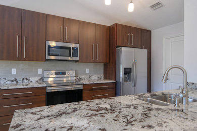Mid-sized minimalist galley open concept kitchen photo in Tampa with flat-panel cabinets, medium tone wood cabinets, quartz countertops and an island