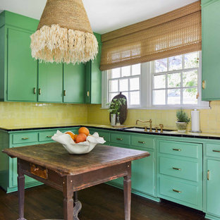 Inspiration for a tropical kitchen in Other with an undermount sink, flat-panel cabinets, green cabinets, tile benchtops, yellow splashback, dark hardwood floors, with island, brown floor and yellow benchtop.