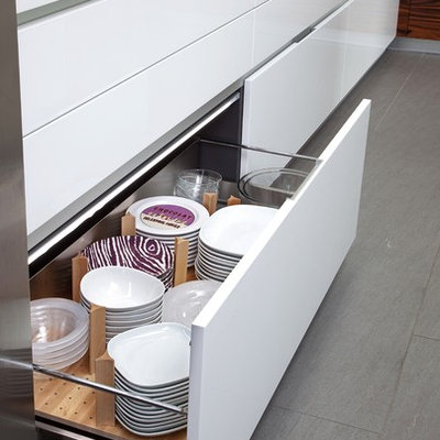 Inspiration for a large modern porcelain tile eat-in kitchen remodel in New York with an undermount sink, flat-panel cabinets, white cabinets, quartz countertops, stainless steel appliances and an island