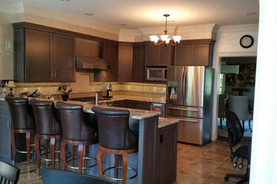 Example of a large minimalist u-shaped ceramic tile eat-in kitchen design in Other with an undermount sink, shaker cabinets, dark wood cabinets, granite countertops, multicolored backsplash, mosaic tile backsplash, stainless steel appliances and no island