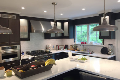 Example of a trendy u-shaped enclosed kitchen design in New York with glass-front cabinets, dark wood cabinets, quartzite countertops, ceramic backsplash, stainless steel appliances and an island