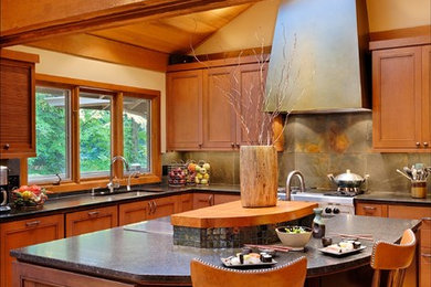 Eat-in kitchen - modern l-shaped light wood floor eat-in kitchen idea in Seattle with an undermount sink, recessed-panel cabinets, medium tone wood cabinets, granite countertops, gray backsplash, stone tile backsplash, stainless steel appliances and an island