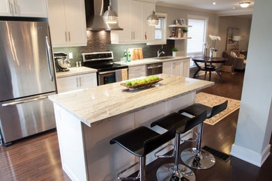 Inspiration for a mid-sized modern single-wall dark wood floor eat-in kitchen remodel in Toronto with recessed-panel cabinets, white cabinets, marble countertops, gray backsplash, stainless steel appliances and an island