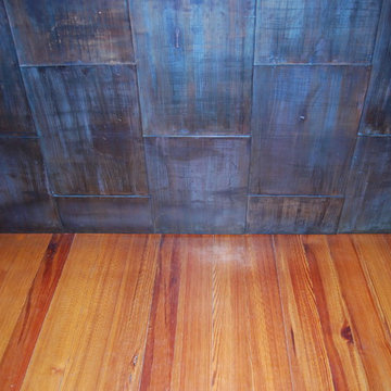 Modern kitchen island copper detail at wood floor.