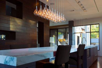 Example of a large trendy u-shaped dark wood floor eat-in kitchen design in New York with a double-bowl sink, raised-panel cabinets, distressed cabinets, granite countertops, multicolored backsplash, stainless steel appliances and an island