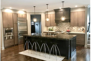Example of a large minimalist l-shaped dark wood floor and brown floor eat-in kitchen design in New York with an undermount sink, flat-panel cabinets, light wood cabinets, quartz countertops, multicolored backsplash, ceramic backsplash, stainless steel appliances, an island and black countertops