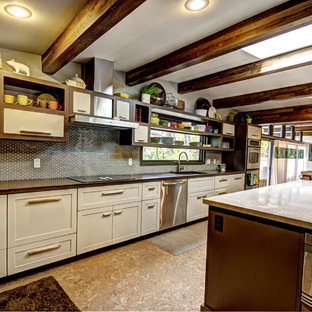 This is an example of a midcentury kitchen in Grand Rapids with concrete benchtops, open cabinets, white cabinets, grey splashback and stainless steel appliances.