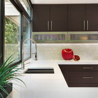 Example of a mid-sized minimalist l-shaped enclosed kitchen design in Providence with an undermount sink, flat-panel cabinets, dark wood cabinets, quartz countertops, gray backsplash, matchstick tile backsplash, stainless steel appliances and no island