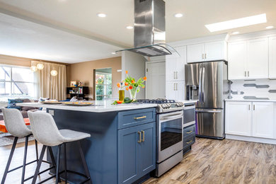 Example of a mid-sized minimalist kitchen design in Portland with multicolored backsplash, ceramic backsplash, stainless steel appliances, an island and white countertops