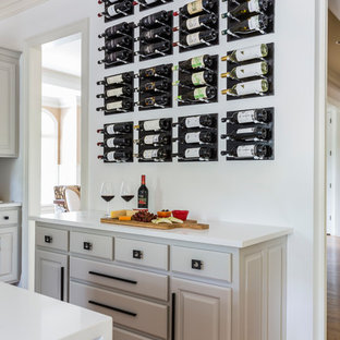 Foto de cocina comedor en U, moderna, de tamaño medio, con fregadero bajoencimera, armarios con paneles con relieve, puertas de armario beige, encimera de cuarcita, salpicadero blanco, salpicadero de mármol, electrodomésticos de acero inoxidable, suelo de contrachapado, una isla, suelo amarillo y encimeras blancas