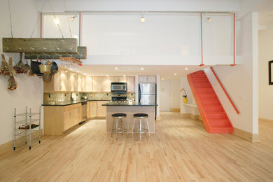 Eat-in kitchen - mid-sized contemporary l-shaped light wood floor eat-in kitchen idea in New York with a drop-in sink, recessed-panel cabinets, light wood cabinets, granite countertops, multicolored backsplash, ceramic backsplash, stainless steel appliances and an island