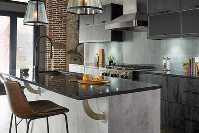 Eat-in kitchen - mid-sized modern single-wall brown floor eat-in kitchen idea in New York with an undermount sink, flat-panel cabinets, black cabinets, solid surface countertops, gray backsplash, glass sheet backsplash, stainless steel appliances, an island and black countertops