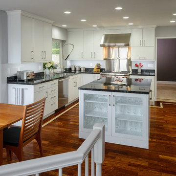 Modern Kitchen With Bold Hardwood Floors & White Flat Panel Cabinets